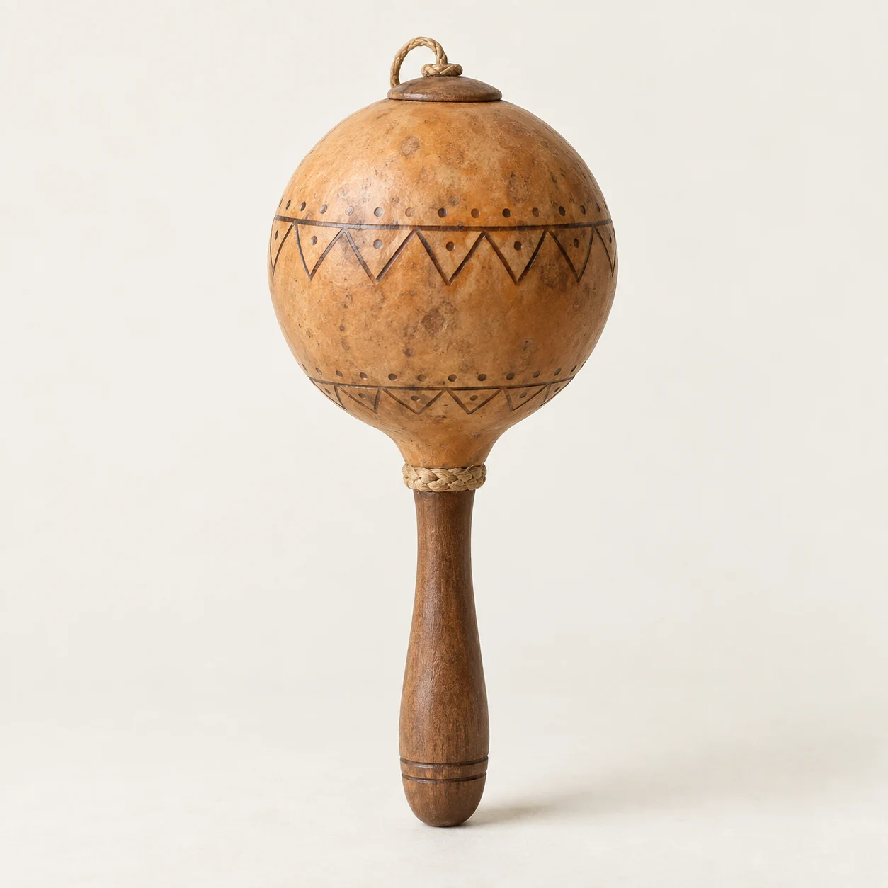 Sonaja de calabaza. Imagen ilustrativa generada por IA; materiales: calabaza, semillas y madera.